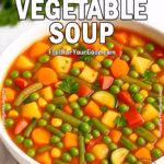 Slow-Cooker Vegetable Soup featuring vibrant, finely chopped vegetables in a rich, savory broth, garnished with fresh parsley. A cozy and hearty recipe from FoodForYourGood.com