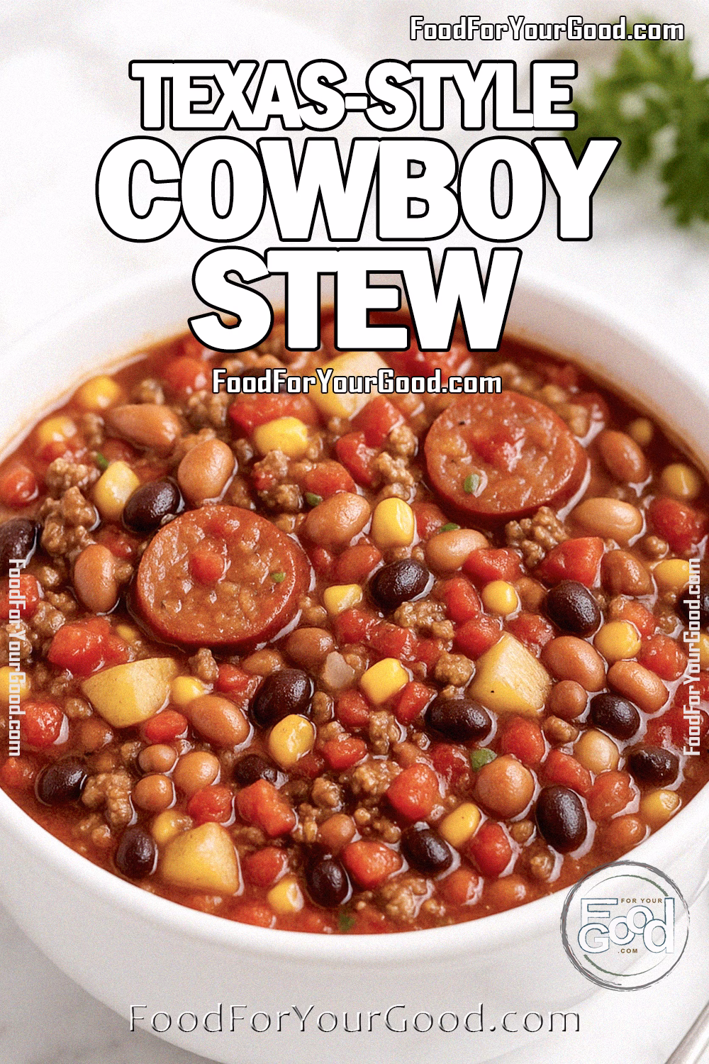 Homemade Texas-Style Cowboy Stew served in a heavy white bowl on a marble countertop with sausage slices, ground beef, beans, potatoes, corn, and fire-roasted tomatoes, garnished with herbs and a spoon on the side | FoodForYourGood.com
