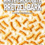White chocolate pretzel bark with pretzel sticks and white chocolate chips on a creamy surface, styled in a bright and appetizing overhead view