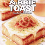Close-up of crispy sourdough toast topped with melty Brie cheese, golden caramelized onions, and a drizzle of honey, garnished with fresh thyme.