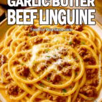 A rich and creamy Cheesy Garlic Butter Beef Linguine served on a rustic plate, featuring tender linguine coated in a velvety garlic butter sauce with savory ground beef and melted parmesan cheese. Freshly chopped parsley adds a vibrant touch. A perfect comforting pasta dish from FoodForYourGood.com