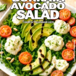 Fresh and vibrant Creamy Burrata Avocado Salad with arugula, ripe avocado slices, cherry tomatoes, burrata cheese, fresh herbs, and toasted pine nuts, drizzled with pesto and olive oil, served on a rustic plate.