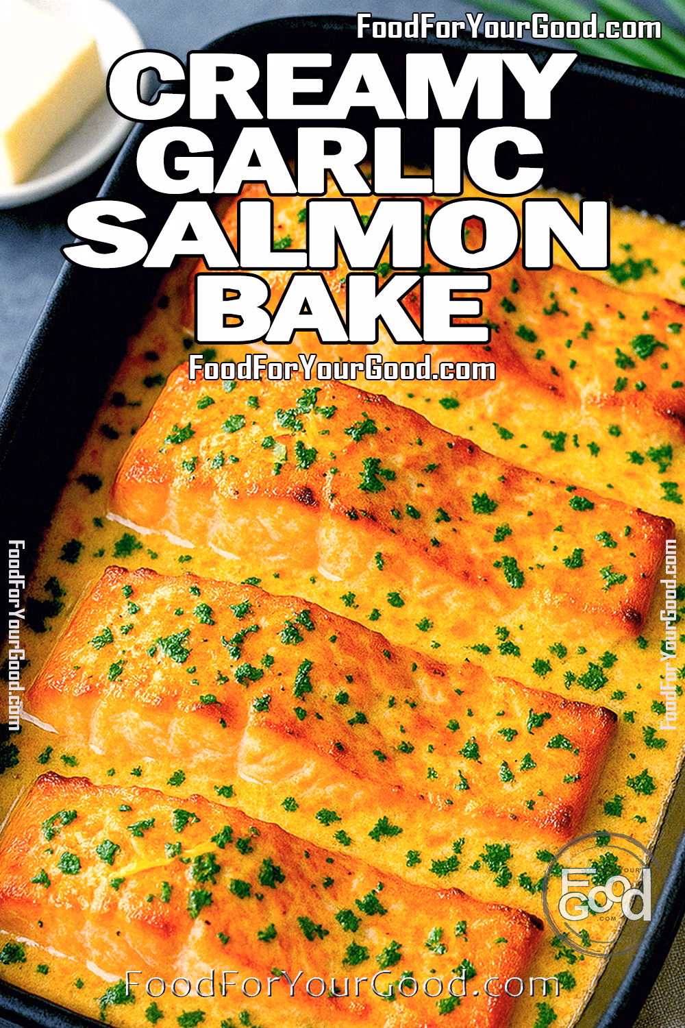Creamy Garlic Butter Baked Salmon | FoodForYourGood.com Creamy Garlic Butter Baked Salmon in black dish topped with fresh parsley on marble background