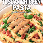Creamy Tuscan Chicken Pasta in a white bowl with penne, chicken, spinach, and sun-dried tomatoes.