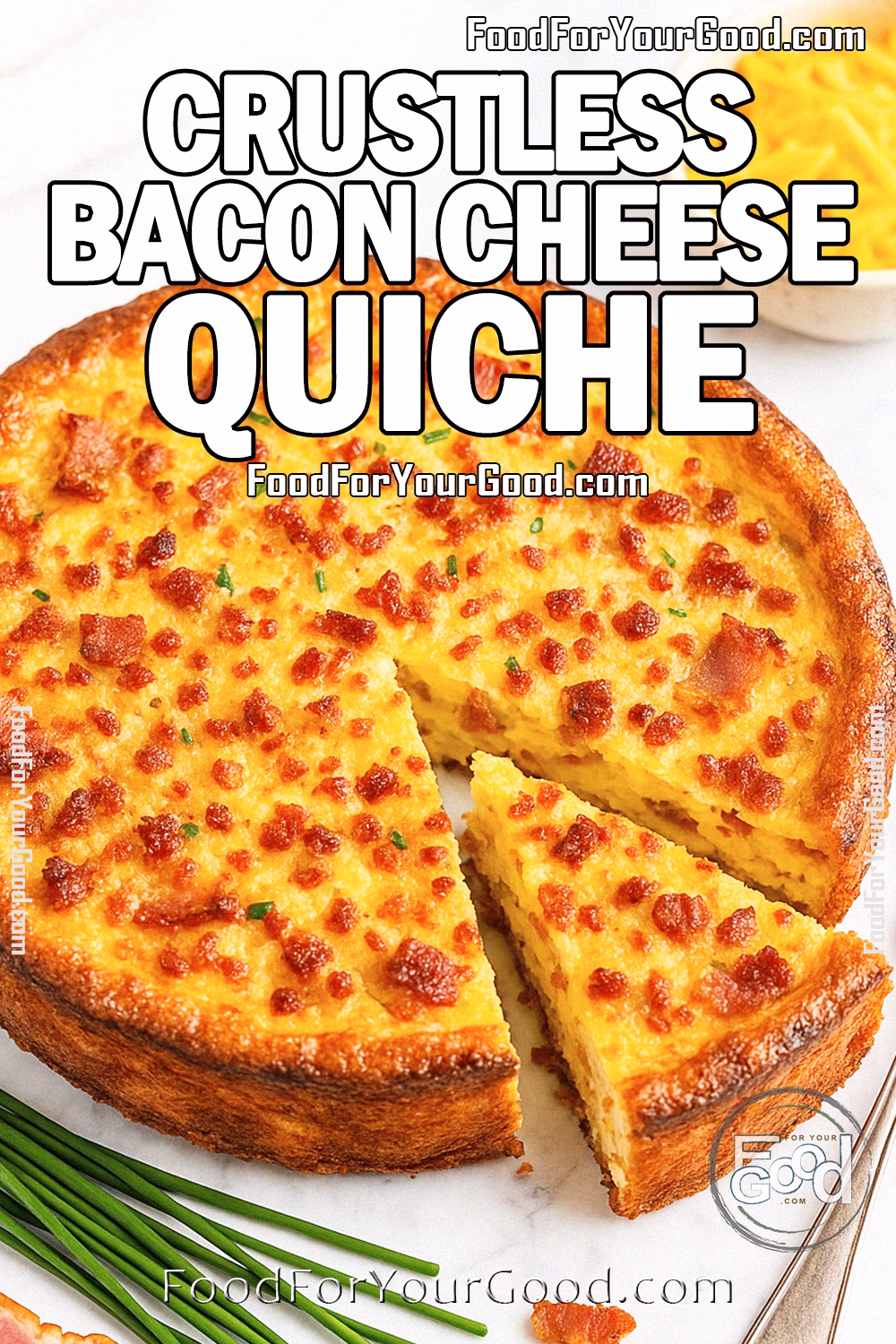 Crustless Bacon Cheese Quiche | FoodForYourGood.com A golden-brown crustless bacon cheese quiche with a slice cut out, surrounded by fresh chives, bacon, and cheddar cheese on a white marble background.