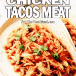Slow Cooker Chicken Tacos Meat served on tortillas with salsa and taco seasoning on a marble background