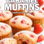 Strawberry Caramel Muffins sliced open on marble board showing gooey caramel center with powdered sugar dusting and fresh strawberries.
