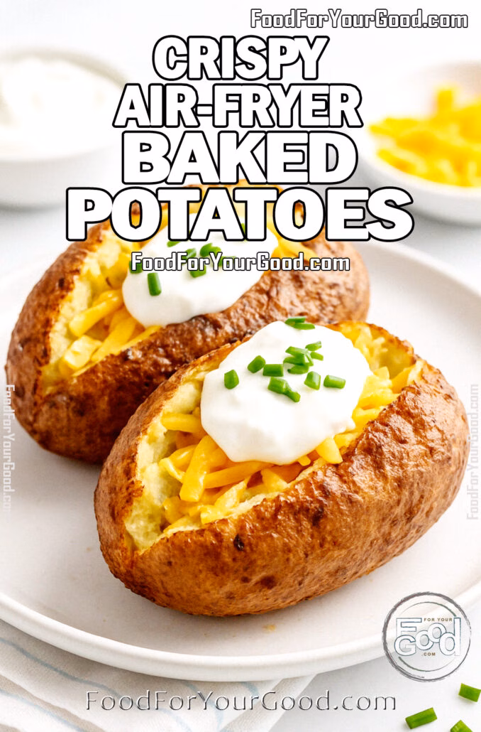Crispy Air-Fryer Baked Potatoes Two crispy air-fried baked potatoes topped with cheddar cheese, sour cream, and chives on a white plate.