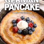 Berry Burst German Pancake with whipped cream and berries in a cast iron skillet