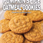 Chewy pumpkin spice oatmeal cookies stacked on a white square plate with a soft white towel in the background