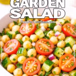 Chickpea garden salad with tomatoes, cucumbers, red onion, and parsley in a white bowl