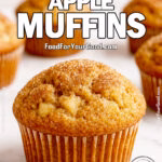 Cinnamon Sugar Apple Muffins on marble surface with golden crusts and sprinkled cinnamon sugar.