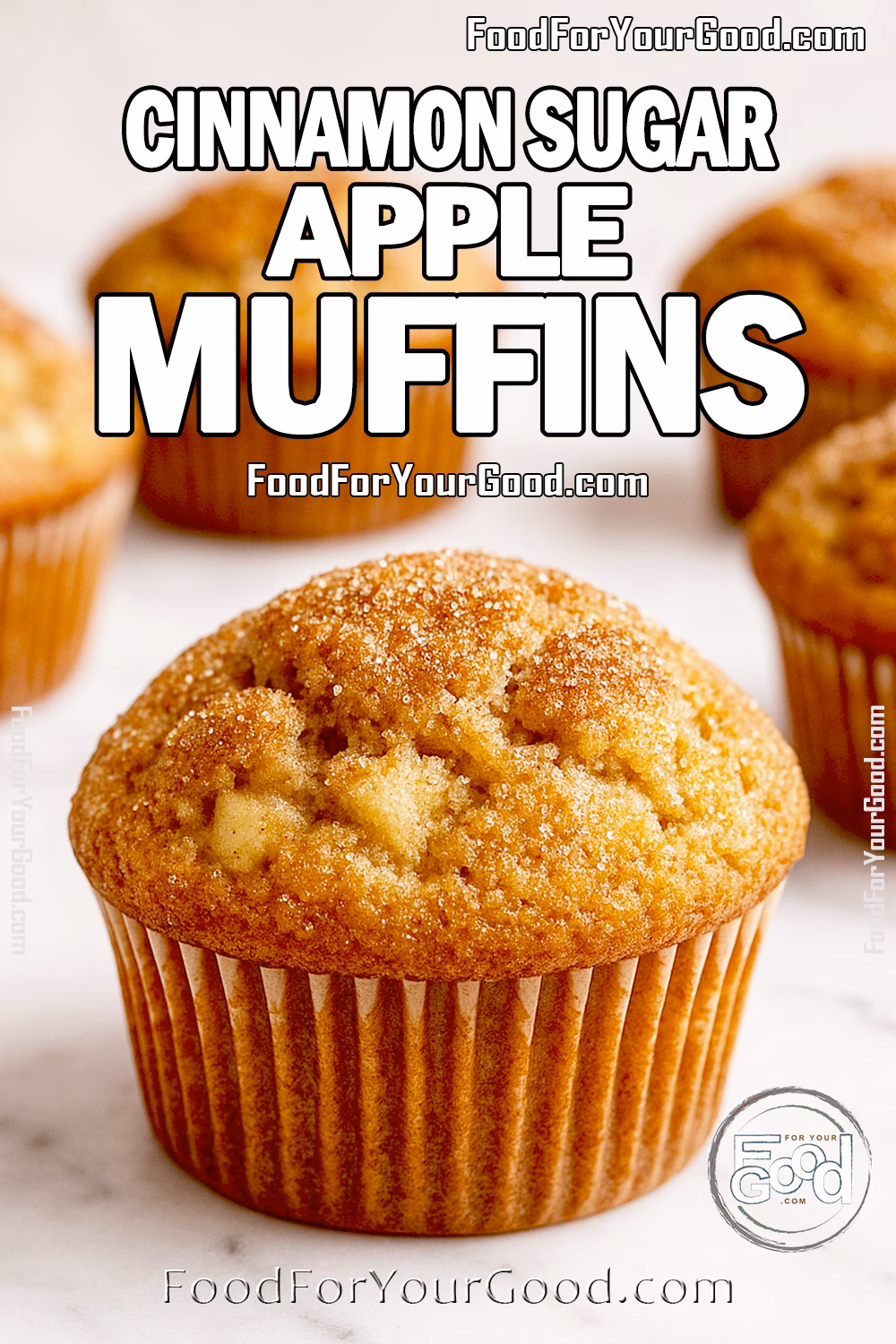 Cinnamon Sugar Apple Muffins Recipe - FoodForYourGood.com Cinnamon Sugar Apple Muffins on marble surface with golden crusts and sprinkled cinnamon sugar.