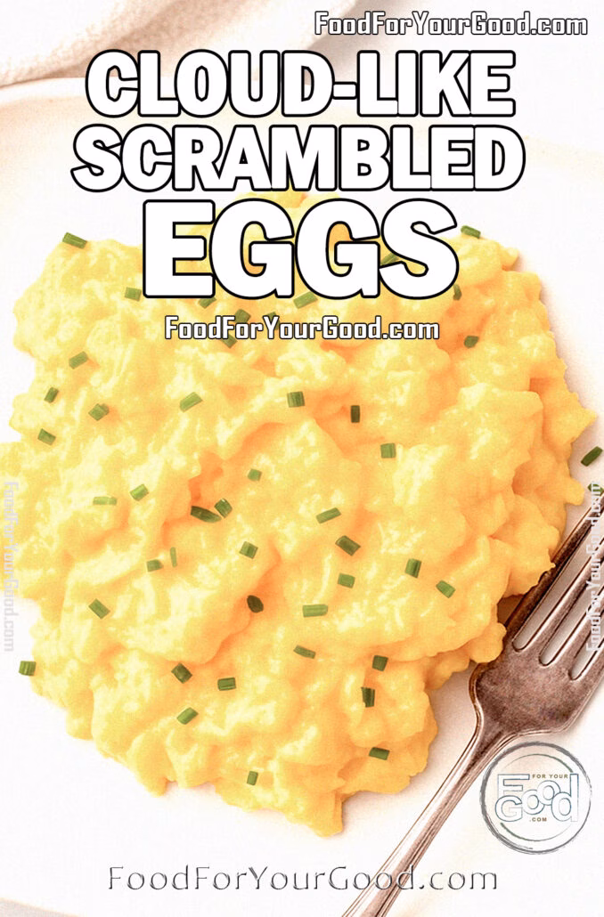 Cloud-Like Scrambled Eggs Cloud-Like Scrambled Eggs served on a white square plate with fork and chives on top, on marble background