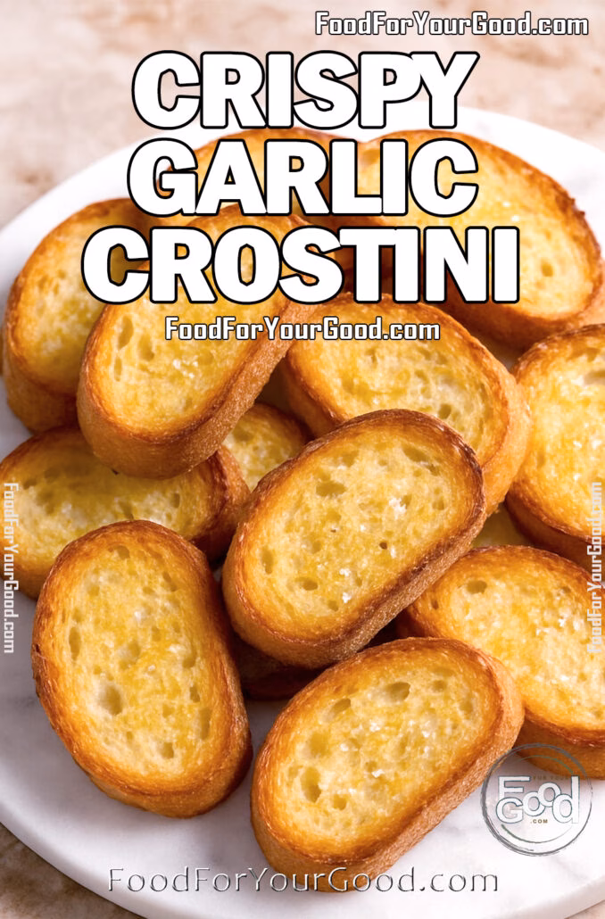Crispy Garlic Crostini A pile of golden, crispy garlic crostini on a white marble plate, perfect as an appetizer base.