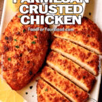 Crispy Parmesan Crusted Chicken served with lemon wedges and honey mustard on white plate