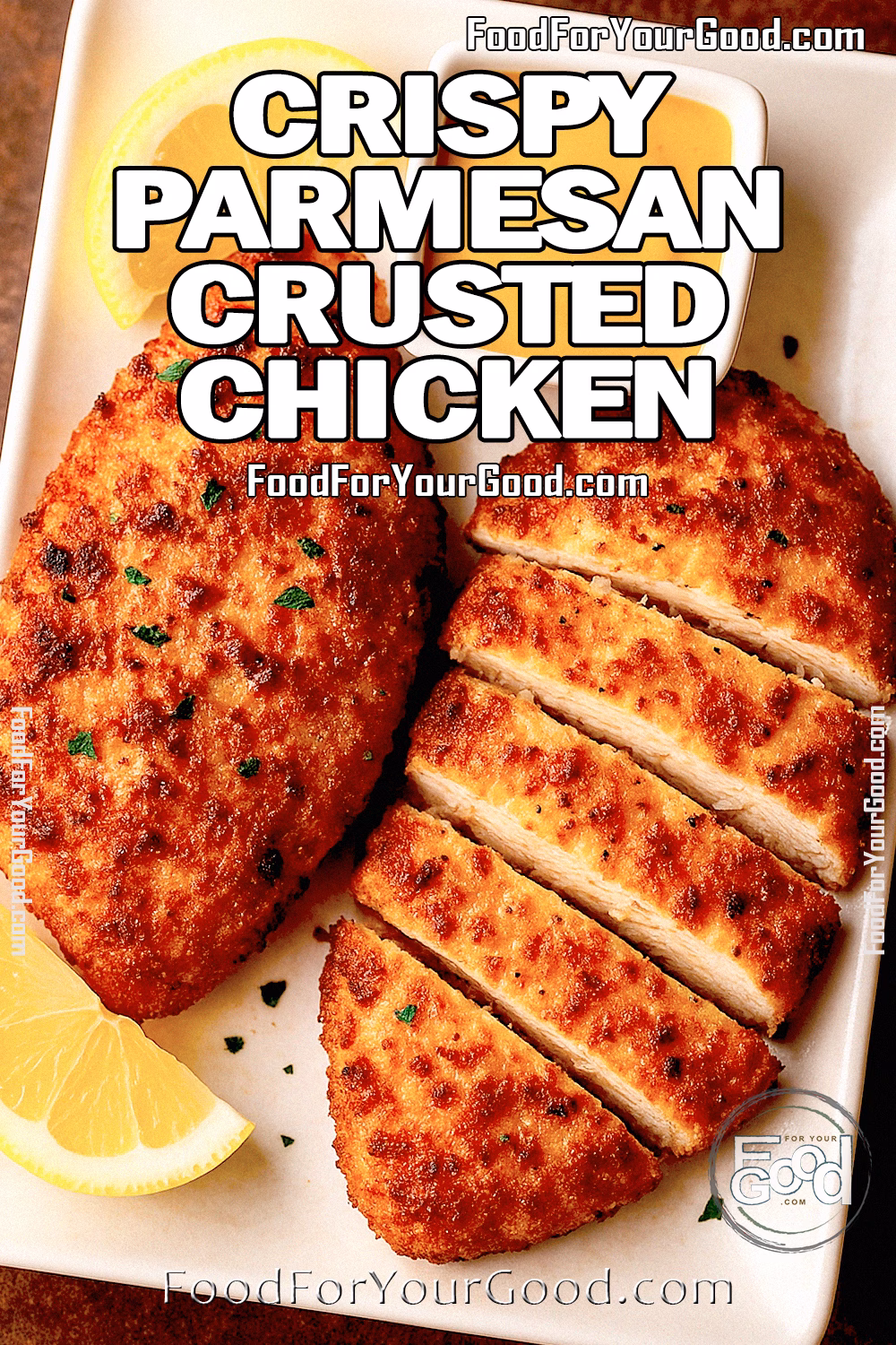 Crispy Parmesan Crusted Chicken served with lemon wedges and honey mustard on white plate