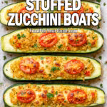 Baked garlic herb stuffed zucchini boats with golden mozzarella and cherry tomatoes on parchment paper.