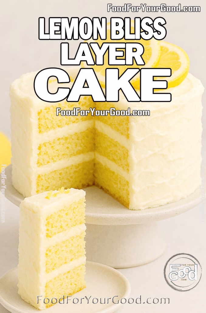 A three-layer Lemon Bliss Layer Cake with cream cheese frosting and lemon slices, served with a slice on a plate in front of the cake on a marble surface.