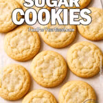 Perfectly Soft Sugar Cookies arranged on parchment paper over a marble surface
