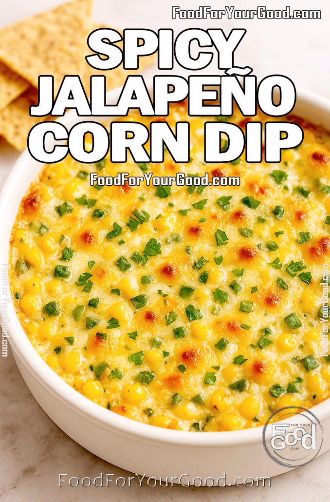 Hot and bubbly Spicy Jalapeño Corn Dip served in a white ceramic dish with golden cheese and fresh herbs on a marble countertop.