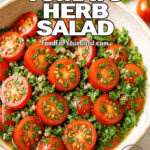 A fresh bowl of Zesty Tomato Herb Salad with halved cherry tomatoes, herbs, and vinaigrette