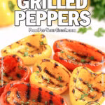 Grilled red and yellow bell pepper halves with charred marks, drizzled with olive oil and balsamic, and sprinkled with parsley on a white square plate.