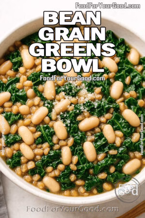 A cozy bowl of the Bean Grain Greens Bowl with kale, white beans, and farro on FoodForYourGood.com