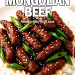 A bowl of Better-Than-Takeout Mongolian Beef with crispy beef strips and green onions in glossy sauce over white rice.
