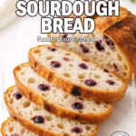 Blueberry Lemon Sourdough Bread, sliced on a white marble board with a golden crust and blueberry-studded crumb in bright daylight.