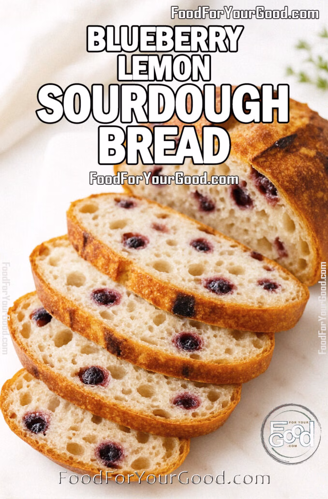 Blueberry Lemon Sourdough Bread, sliced on a white marble board with a golden crust and blueberry-studded crumb in bright daylight.