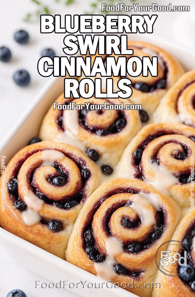 Blueberry Swirl Cinnamon Rolls Blueberry Swirl Cinnamon Rolls baked golden in a white ceramic dish on a marble countertop, swirled with cinnamon sugar and blueberries, topped with cream cheese glaze.
