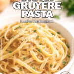 Caramelized Onion Gruyère Pasta served in a white bowl with parsley on marble countertop.