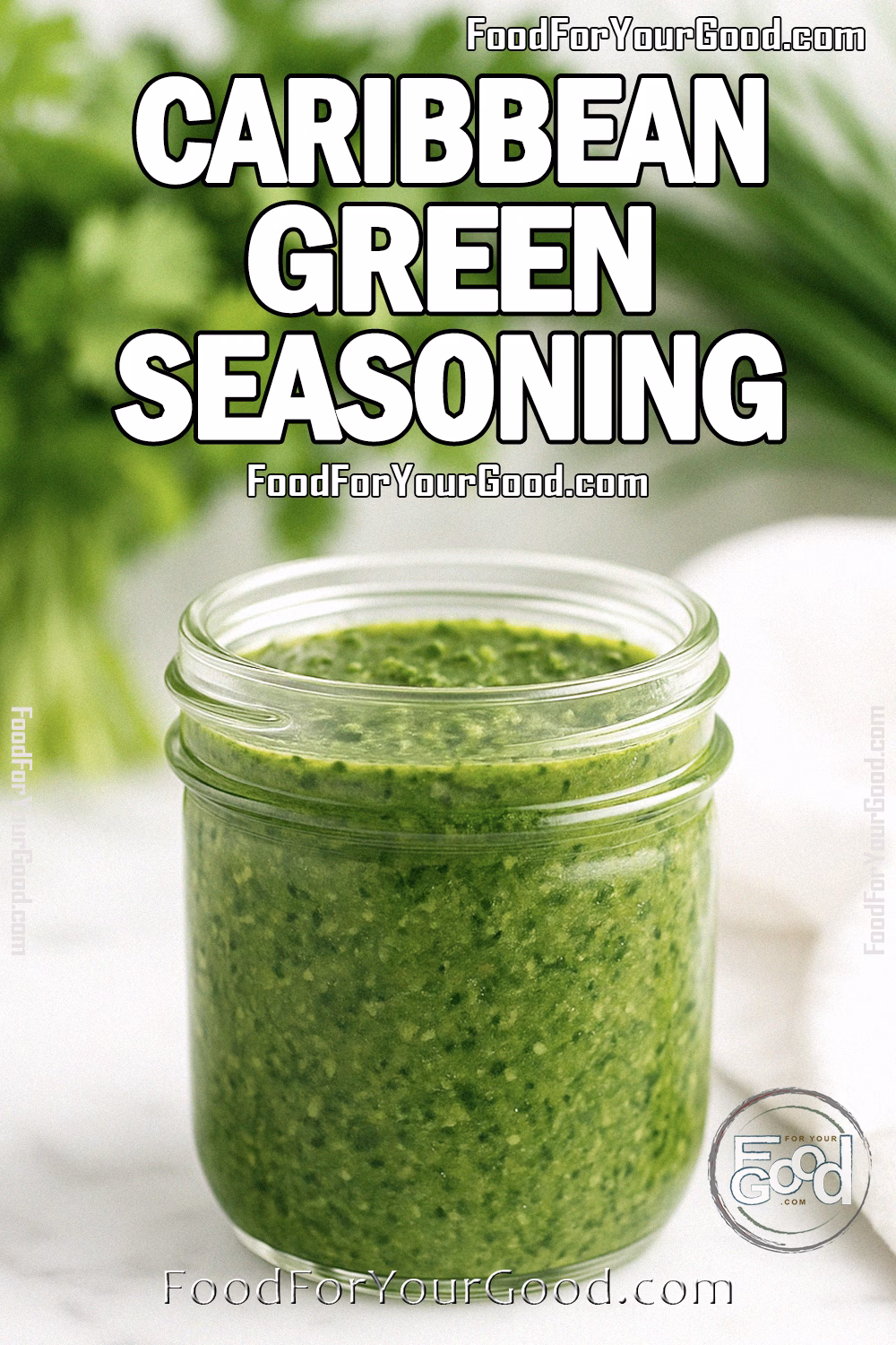 Caribbean Green Seasoning Recipe – FoodForYourGood.com Caribbean Green Seasoning in a small wide-mouth glass jar on white marble, with fresh herbs and a white towel in the background.