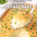 Cheesy Sour Cream Onion Potato Bake in white dish on marble with golden cracker topping and green onion garnish on FoodForYourGood.com