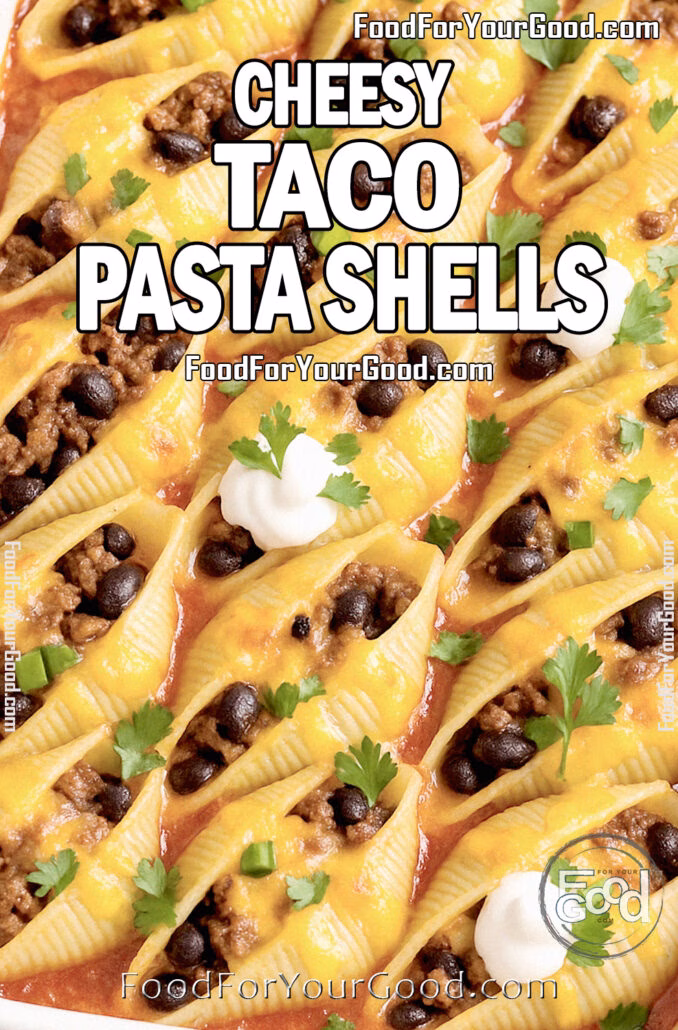 Cheesy Taco Pasta Shells Cheesy Taco Pasta Shells baked in a white ceramic dish, topped with melted cheese, sour cream, and chopped green onions on marble.