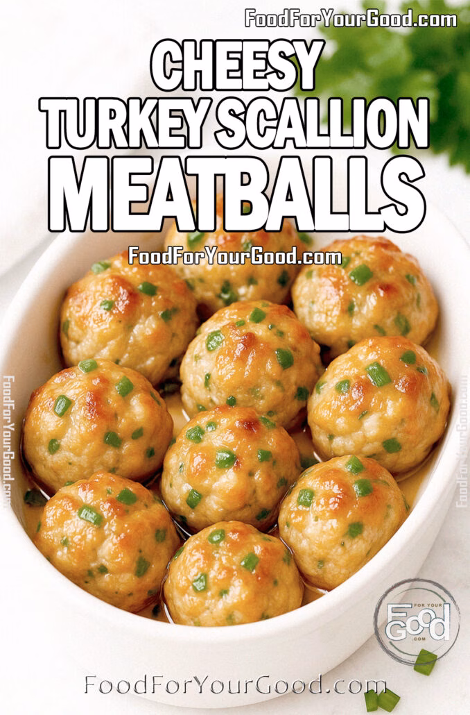 Cheesy Turkey Scallion Meatballs White oval dish filled with moist, golden roasted turkey meatballs brushed lightly with butter for shine, with mozzarella peeking through and scallions inside, garnished with finely chopped scallions. Set on a white marble background with fresh parsley and a white towel blurred in the background.