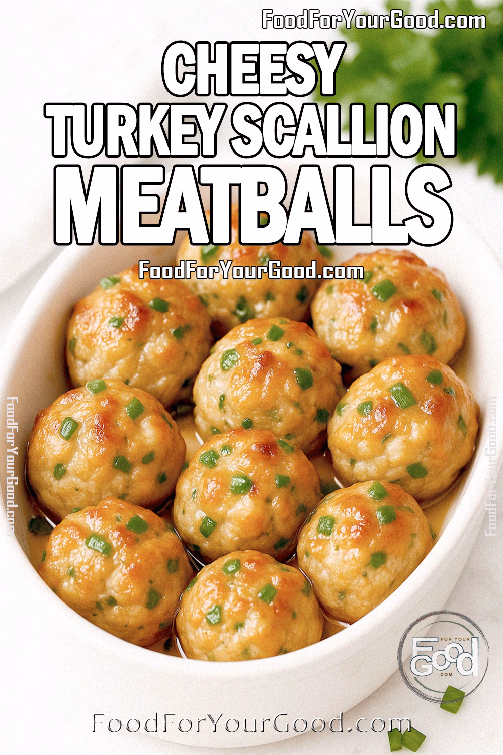 Moist Cheesy Turkey Scallion Meatballs – FoodForYourGood.com White oval dish filled with moist, golden roasted turkey meatballs brushed lightly with butter for shine, with mozzarella peeking through and scallions inside, garnished with finely chopped scallions. Set on a white marble background with fresh parsley and a white towel blurred in the background.