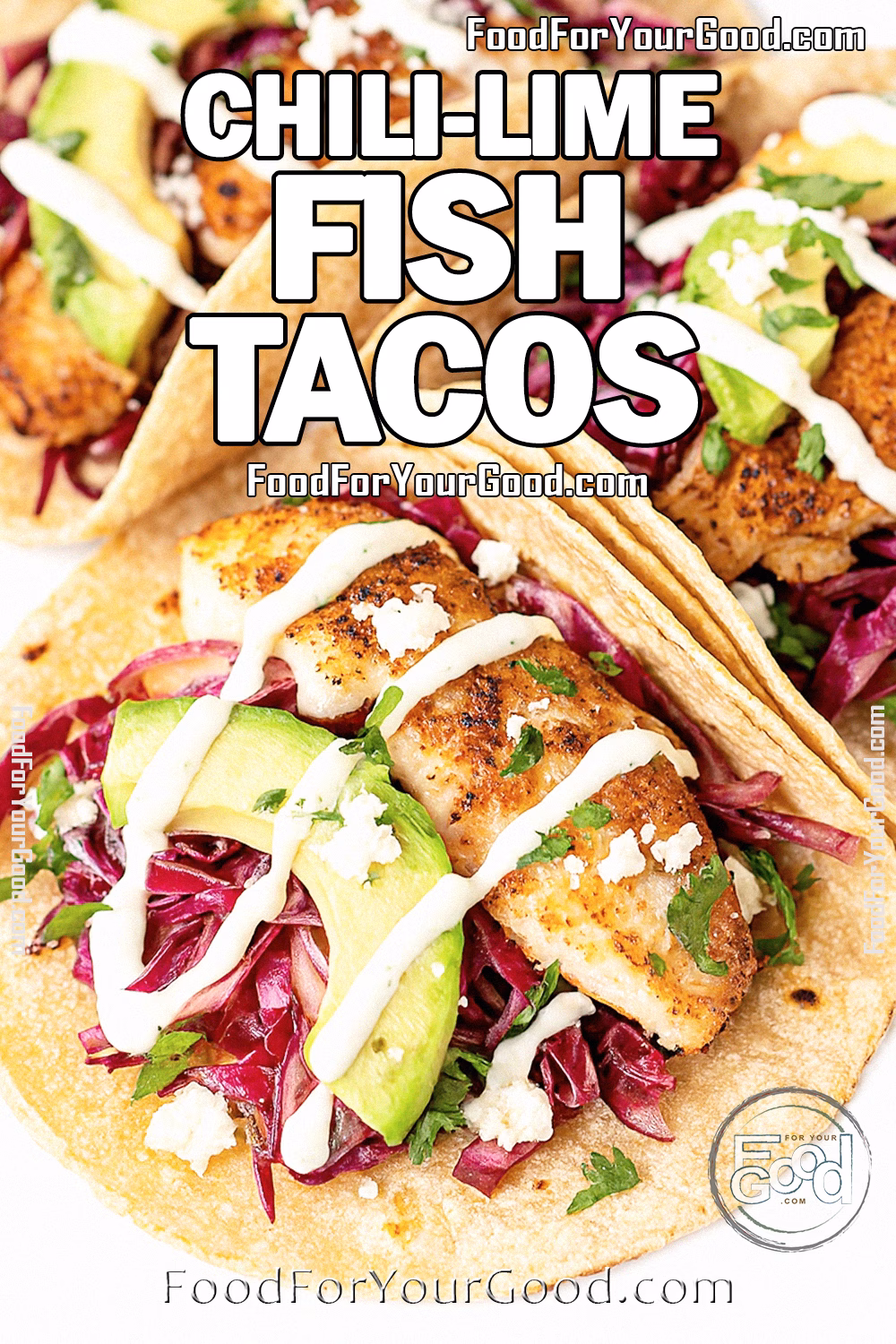 Chili-Lime Fish Tacos on white marble with avocado slices, shredded red cabbage, cotija cheese, and cilantro-lime sauce drizzle.