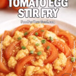 Chinese Tomato Egg Stir Fry with scallions served on a white plate with rice on FoodForYourGood.com