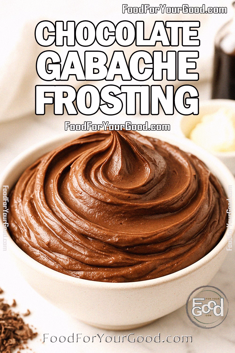 Chocolate Gabache Frosting Recipe – FoodForYourGood.com Chocolate Gabache Frosting in a ceramic bowl on white marble with vanilla, butter, and chopped chocolate in background.