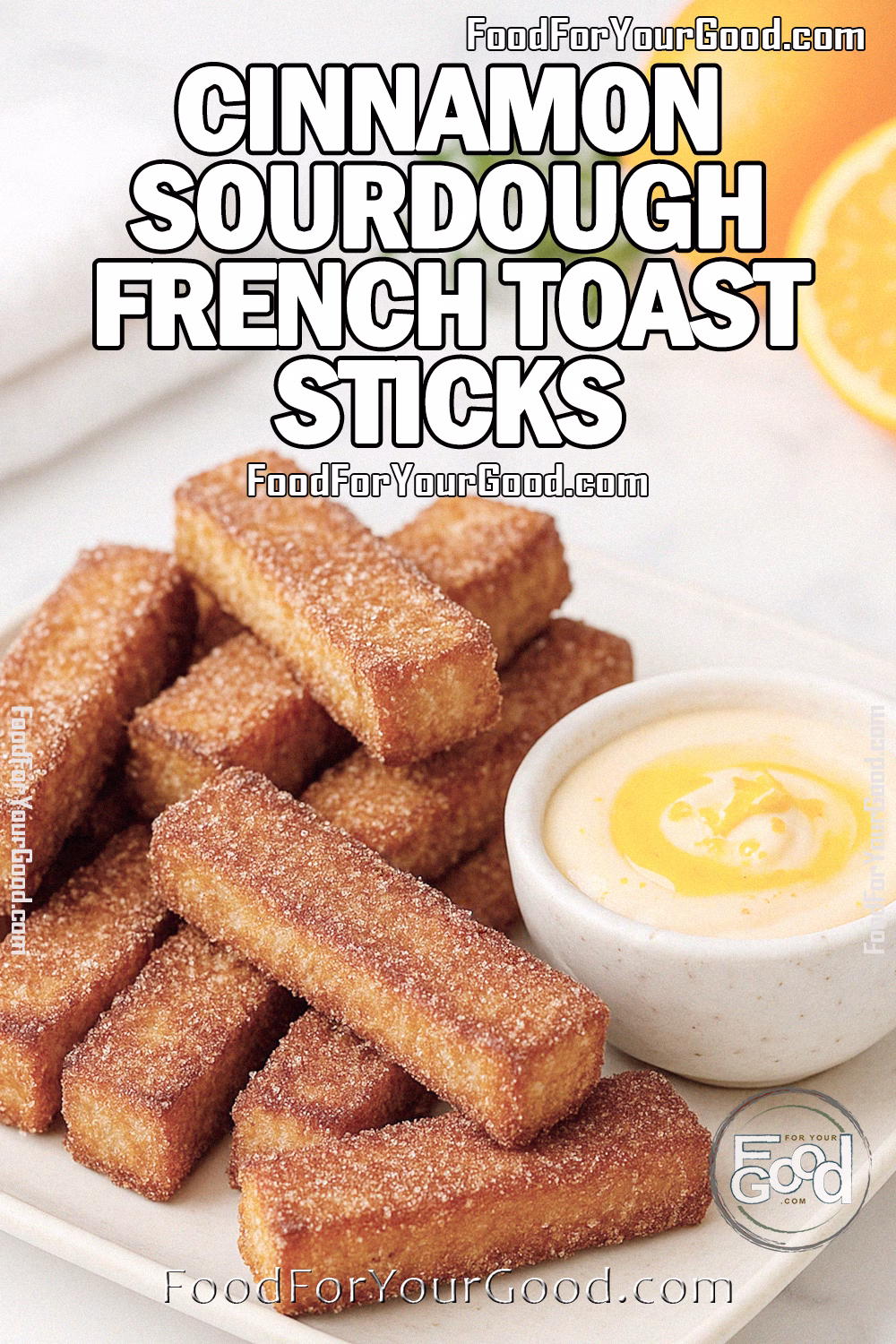 Cinnamon Sourdough French Toast Sticks Recipe with Orange Honey Butter Dip – FoodForYourGood.com Cinnamon Sourdough French Toast Sticks with orange honey butter dip on a white marble surface, styled with oranges and herbs for FoodForYourGood.com