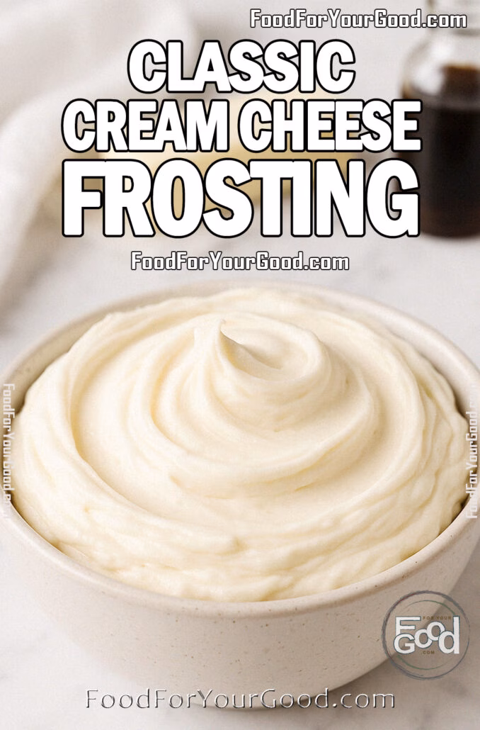 Classic Cream Cheese Frosting A creamy swirl of Classic Cream Cheese Frosting in a white bowl, set on a marble countertop with butter, vanilla, and a white kitchen towel in the background, photographed for FoodForYourGood.com