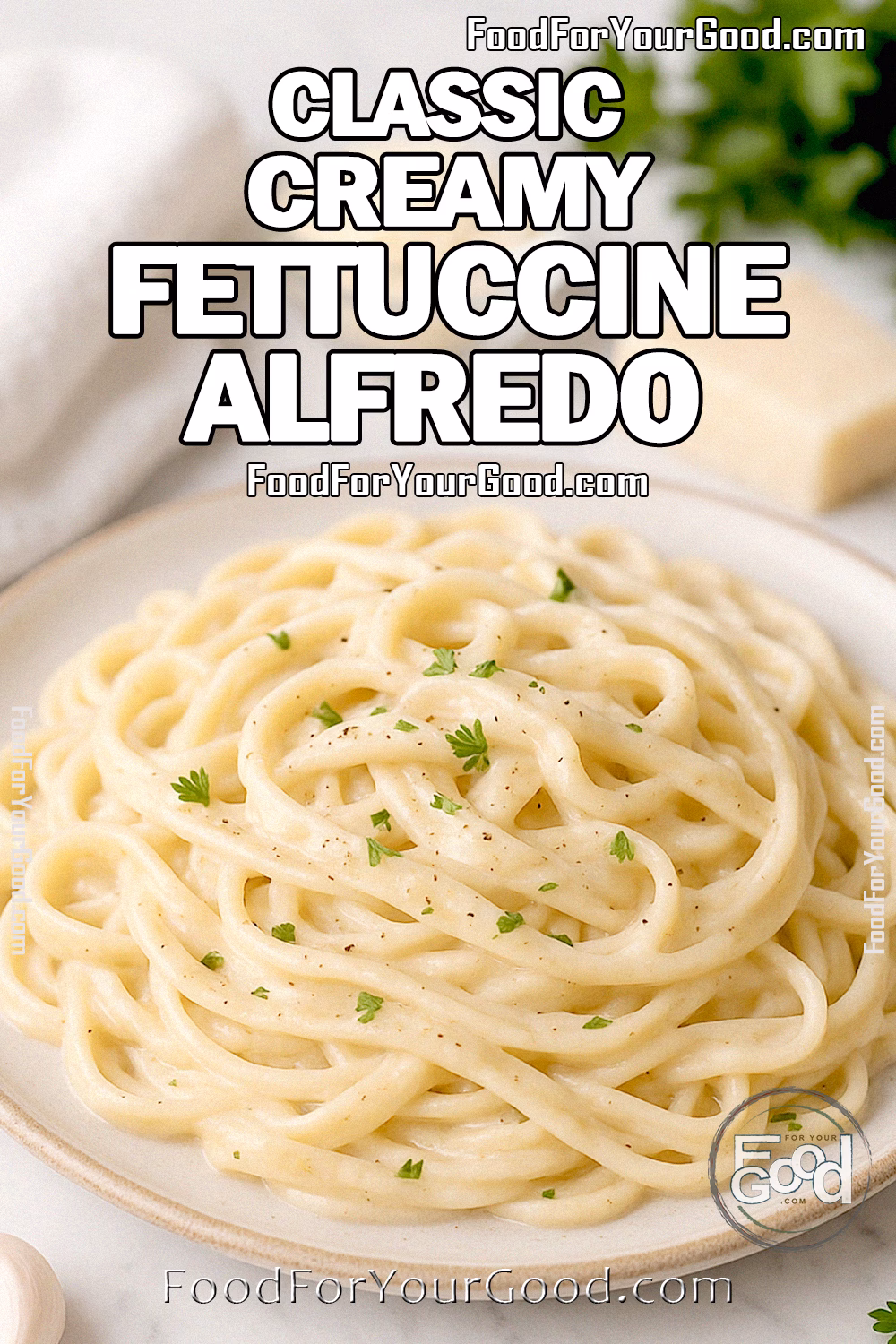 Classic Creamy Fettuccine Alfredo Recipe - FoodForYourGood.com Classic Creamy Fettuccine Alfredo on white plate with Parmesan, garlic, and parsley on marble background.