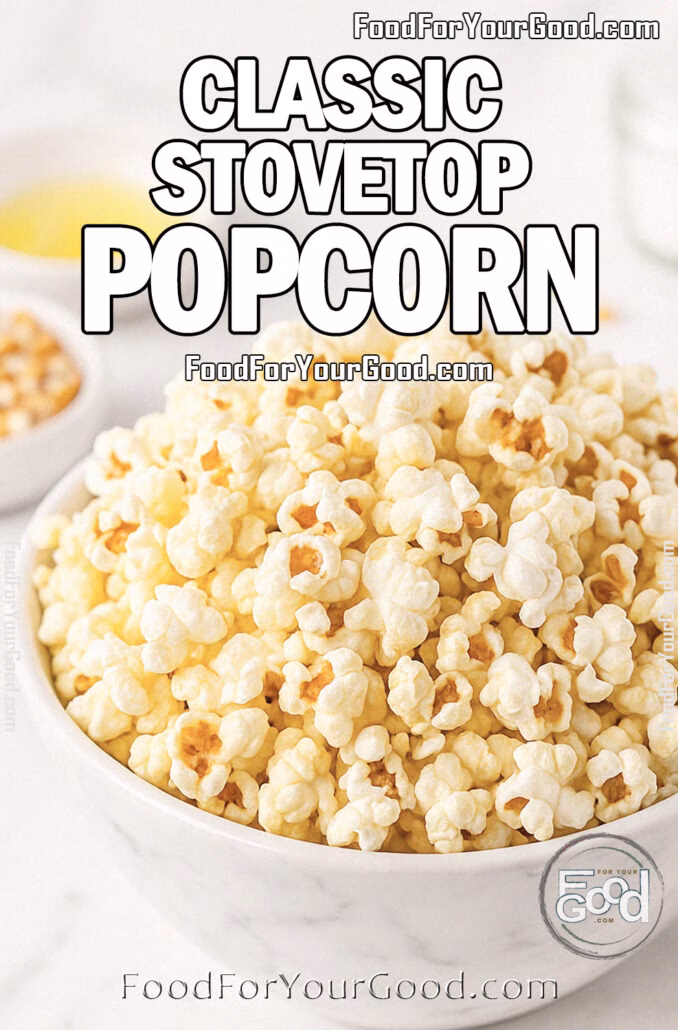 A large white marble bowl filled with fluffy golden stovetop popcorn, lightly drizzled with butter, on a marble countertop with salt and kernels blurred in the background.