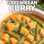 A bowl of Coconut Sweet Potato Green Bean Curry with tender sweet potato cubes, green beans, and cilantro on a white marble surface.