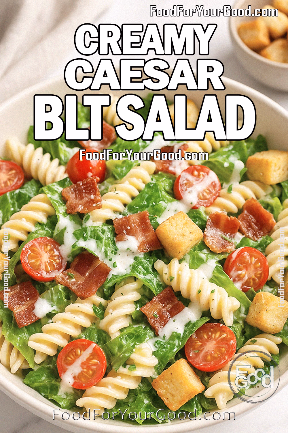 Creamy Caesar BLT Salad Recipe - FoodForYourGood.com Creamy Caesar BLT Salad in a white bowl with pasta, bacon, lettuce, and cherry tomatoes on a marble background.
