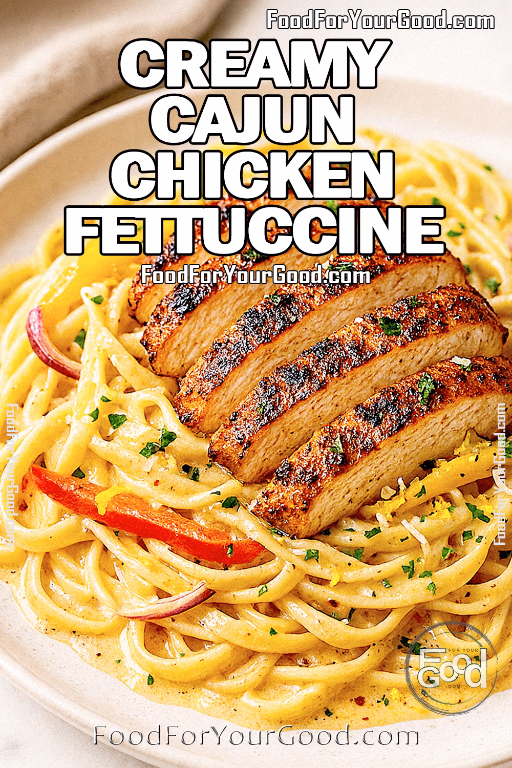 Creamy Cajun Chicken Fettuccine topped with sliced blackened chicken and bell peppers on a white plate.