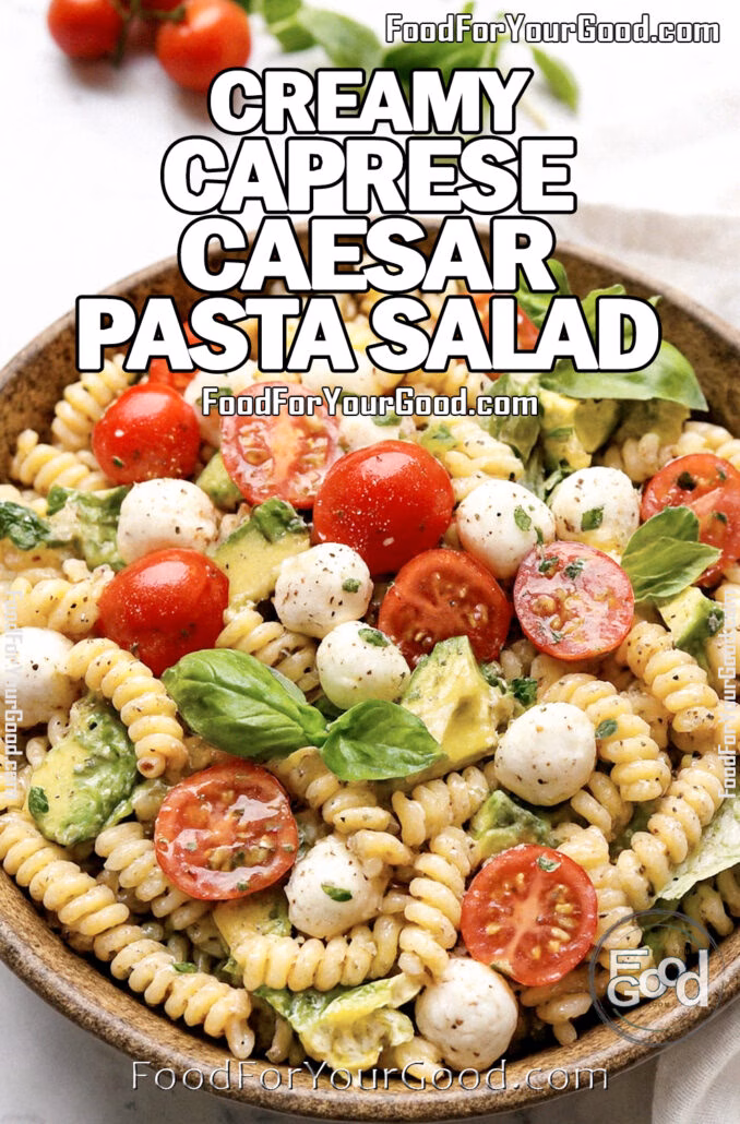 Creamy Caprese Caesar Pasta Salad with rotini, cherry tomatoes, mozzarella, basil, and Caesar dressing served in a rustic bowl on white marble at FoodForYourGood.com