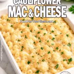 Creamy Cauliflower Mac and Cheese baked with golden breadcrumb topping in white dish on marble
